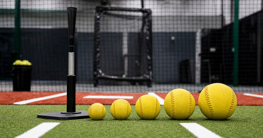 Several weighted softballs arranged from light to heavy beside a practice tee
