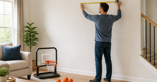 Family measuring a clear indoor wall area before setting up a mini basketball hoop
