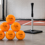 CYFIE weighted softballs beside a batting tee during a controlled hitting drill