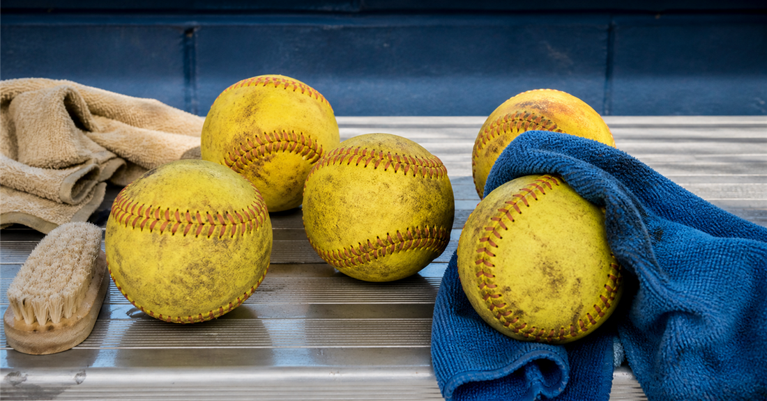 Weighted softballs being wiped and inspected after practice