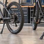 Center-mount and rear-mount bicycle kickstands compared on two bike frames